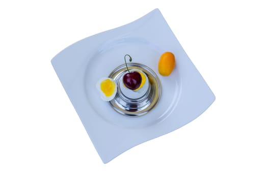 Breakfast egg in which a cherry is stuck