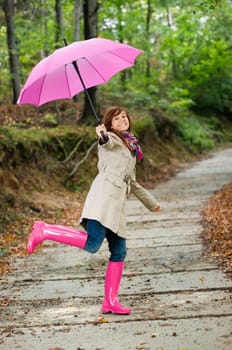 Cute young woman having fun after raining