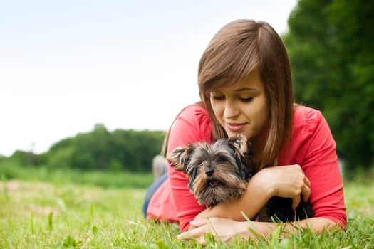 Young woman holding Yorkshire terrier