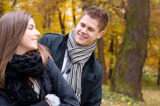 Young couple walking through the park
