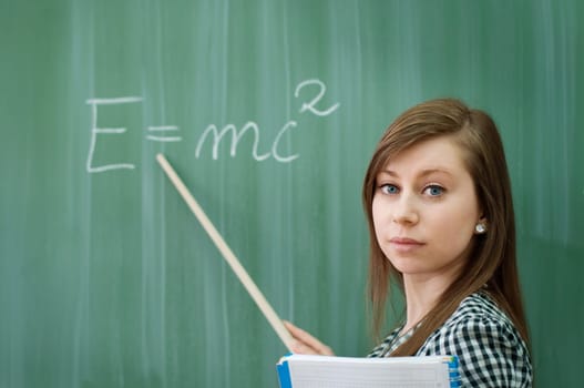 Student girl showing e=mc2 formula