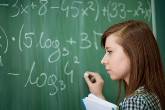 Student girl writing mathematical formula