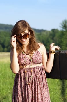 Young woman looking behind sunglasses