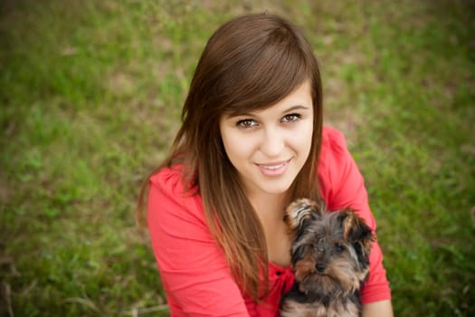 Young woman holding Yorkshire terrier