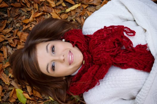 Beauty girl lying down on leaves