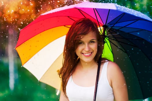 Portrait of beautiful and smiling woman with umbrella
