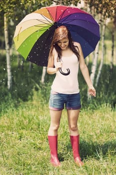 Smiling woman in rainy summer day
