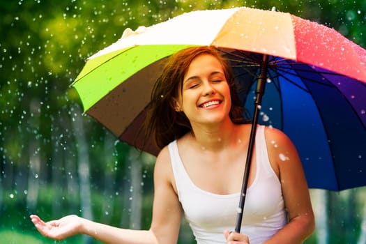 Beautiful woman enjoying summer rain