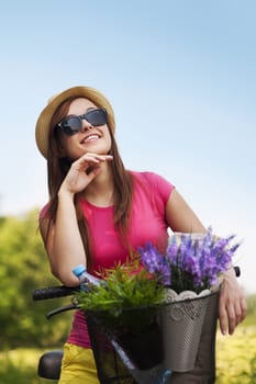 Portrait of beautiful young woman with bike