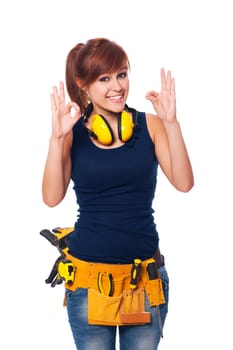 Happy young female construction worker gesturing OK sign