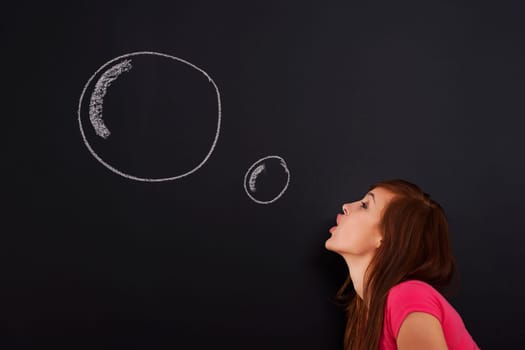 Young woman blowing bubbles