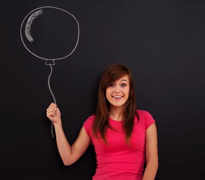 Smiling woman holding in hand balloon