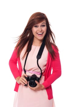 Attractive young woman holding digital camera