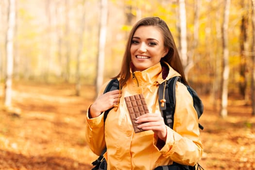 Smiling female hiker with dark chocolate