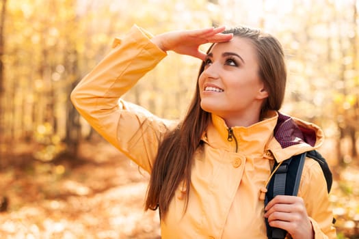 Young smiling female hiker looking far away