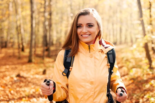 Active beautiful woman hiking in autumn