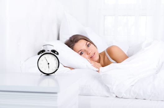 Woman in bed waking up