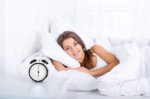 Woman in bed waking up