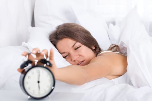 Woman in bed waking up