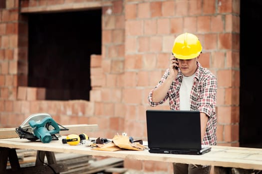 Carpenter talking on mobile phone