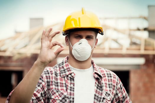 Manual worker with hard hat and protective mask