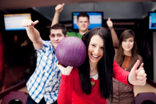 Friends bowling together