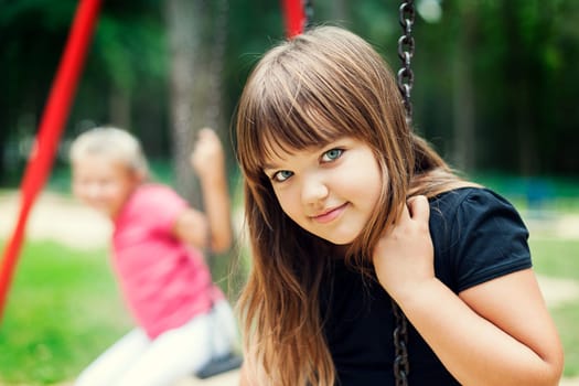 Little girl smiling on swing