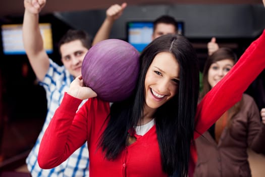 Friends bowling together