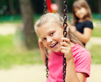 Happy little kid on swing