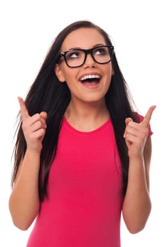 Woman wearing glasses pointing at copy space above her