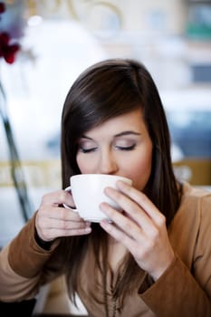 Close up of woman drinking coffee