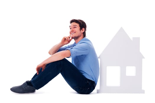 Dreaming man sitting next to a sign home