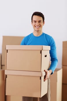 Happy young man holding a cardboard boxes