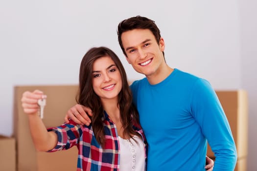 Young couple holding key in hand