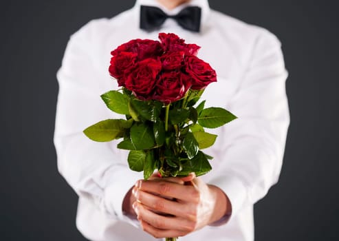 Man giving bouquet of red roses
