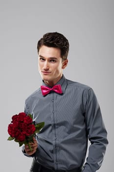 Handsome man holding red roses