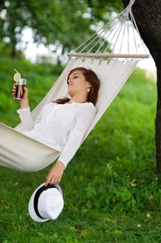Relaxing in hammock with drink