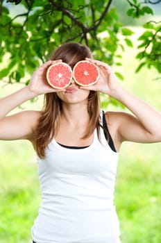 Young woman having fun with fruits