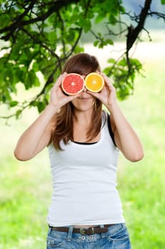 Young woman having fun with fruits