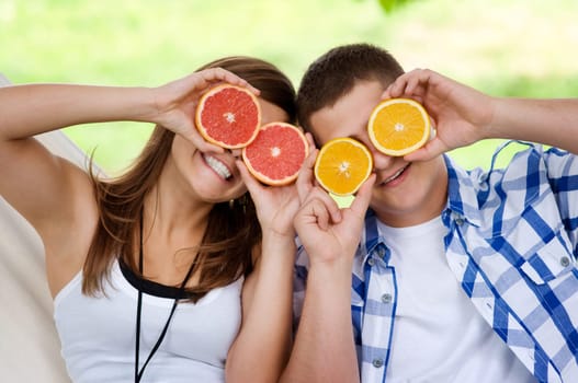 Young couple having fun with fruits