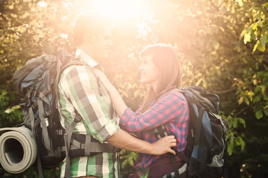 Loving couple in forest at sunset