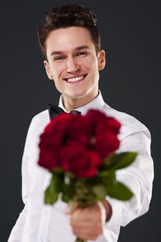 Man giving bouquet of red roses