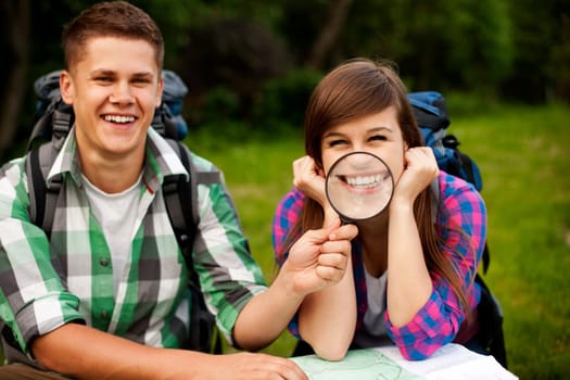 Young couple with map in forest