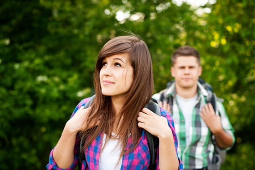 Young couple walking through forest