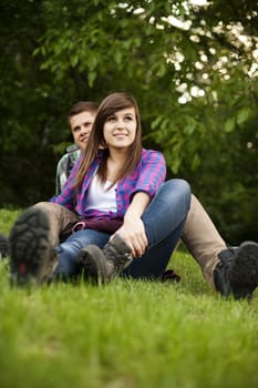 Young couple sitting on glade