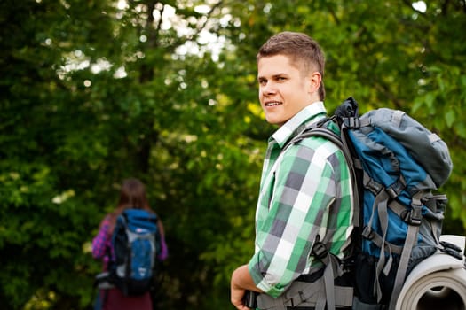 Young couple walking through forest