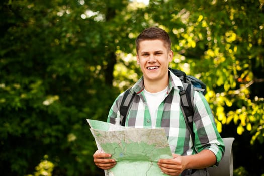 Man holding a map in forest