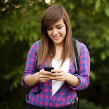 Beautiful female hiker texting