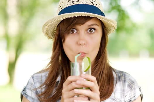 Young woman drinking mojito