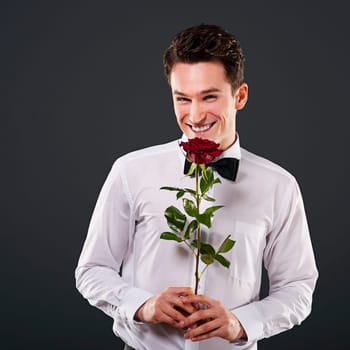 Smiling man with red rose
